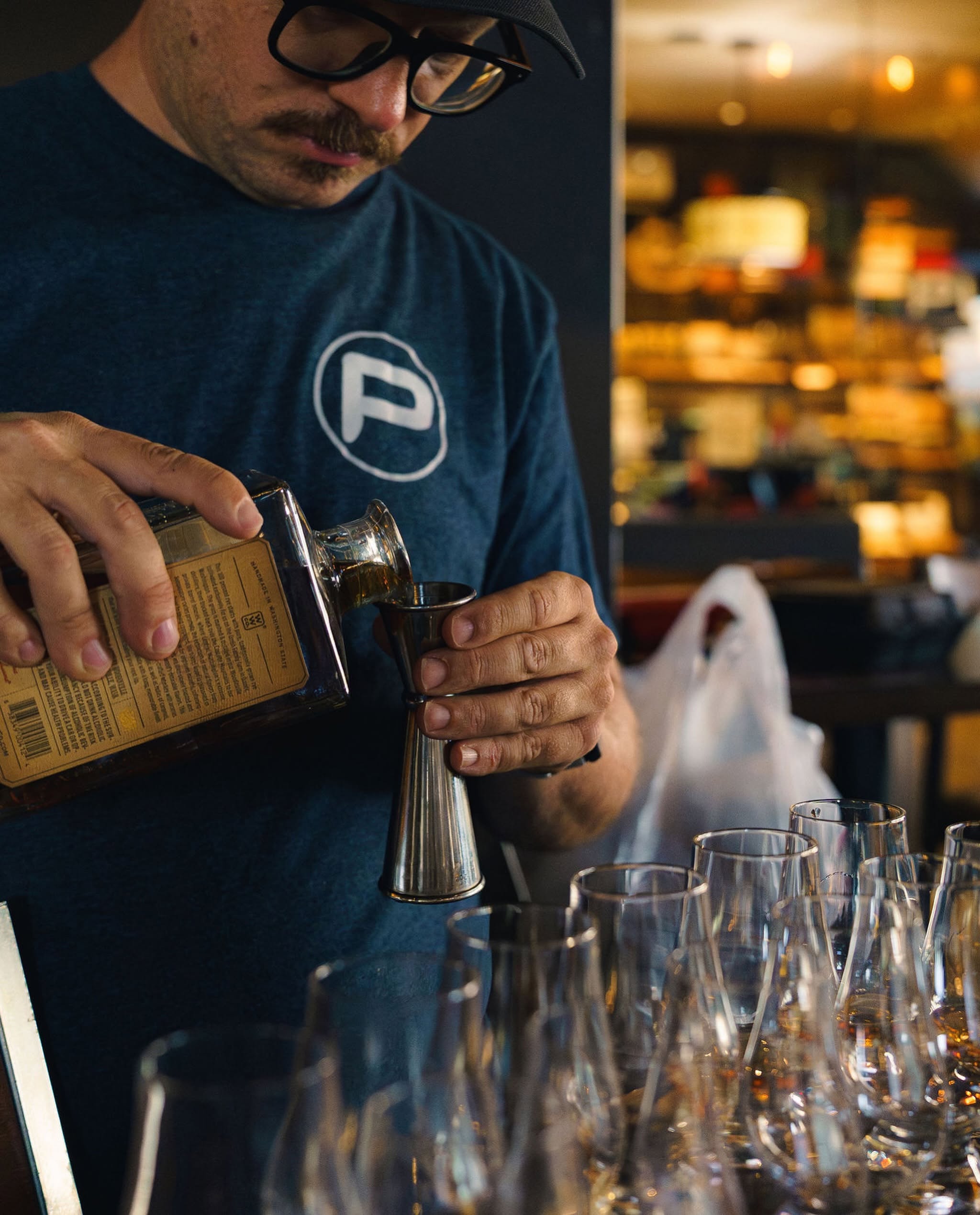 PURO bartender measuring a pour