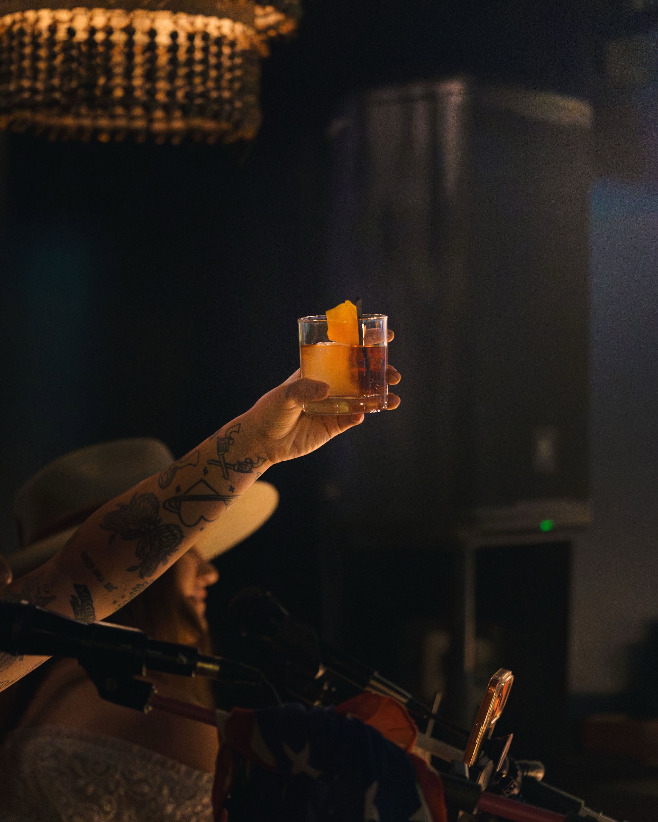 A raised cocktail glass at PURO