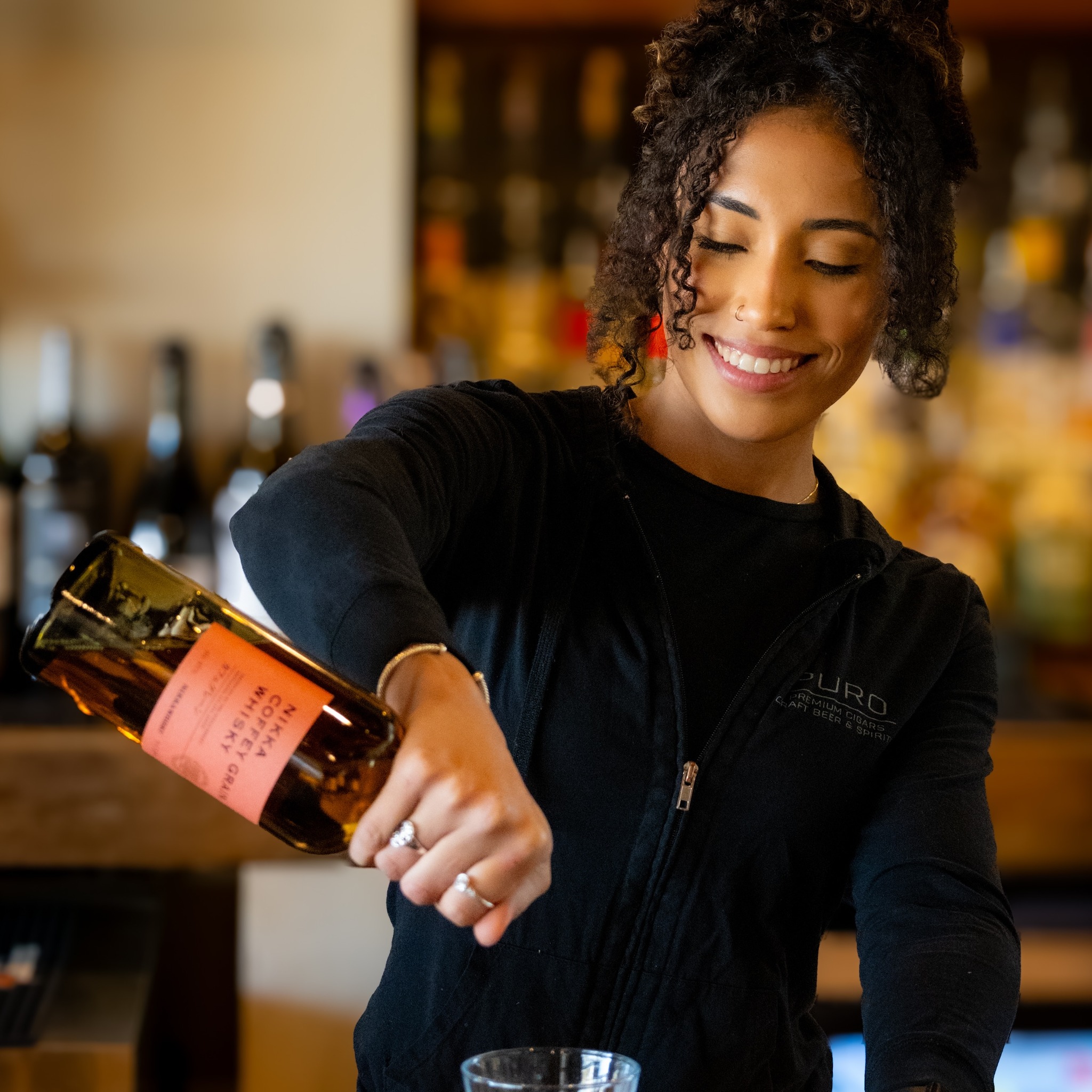 A PURO bartender preparing a drink
